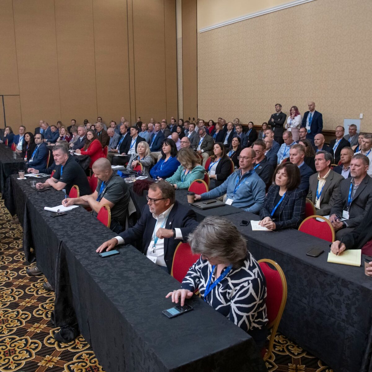 acec members sitting while taking notes during a conference