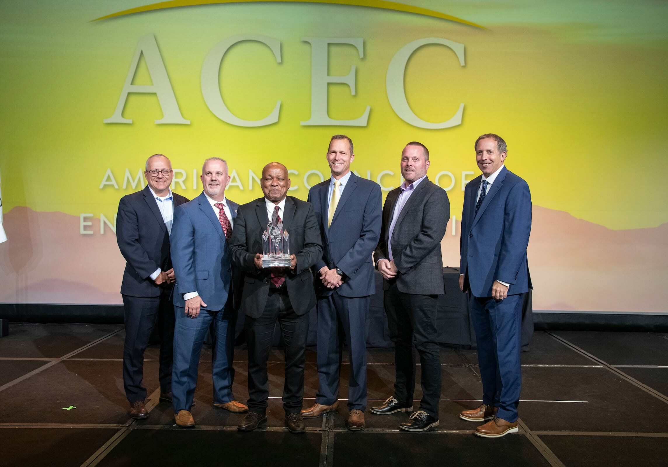 acec members standing on stage during awarding
